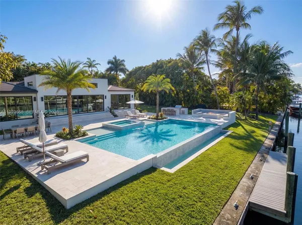 a view of a swimming pool with lounge chairs in patio