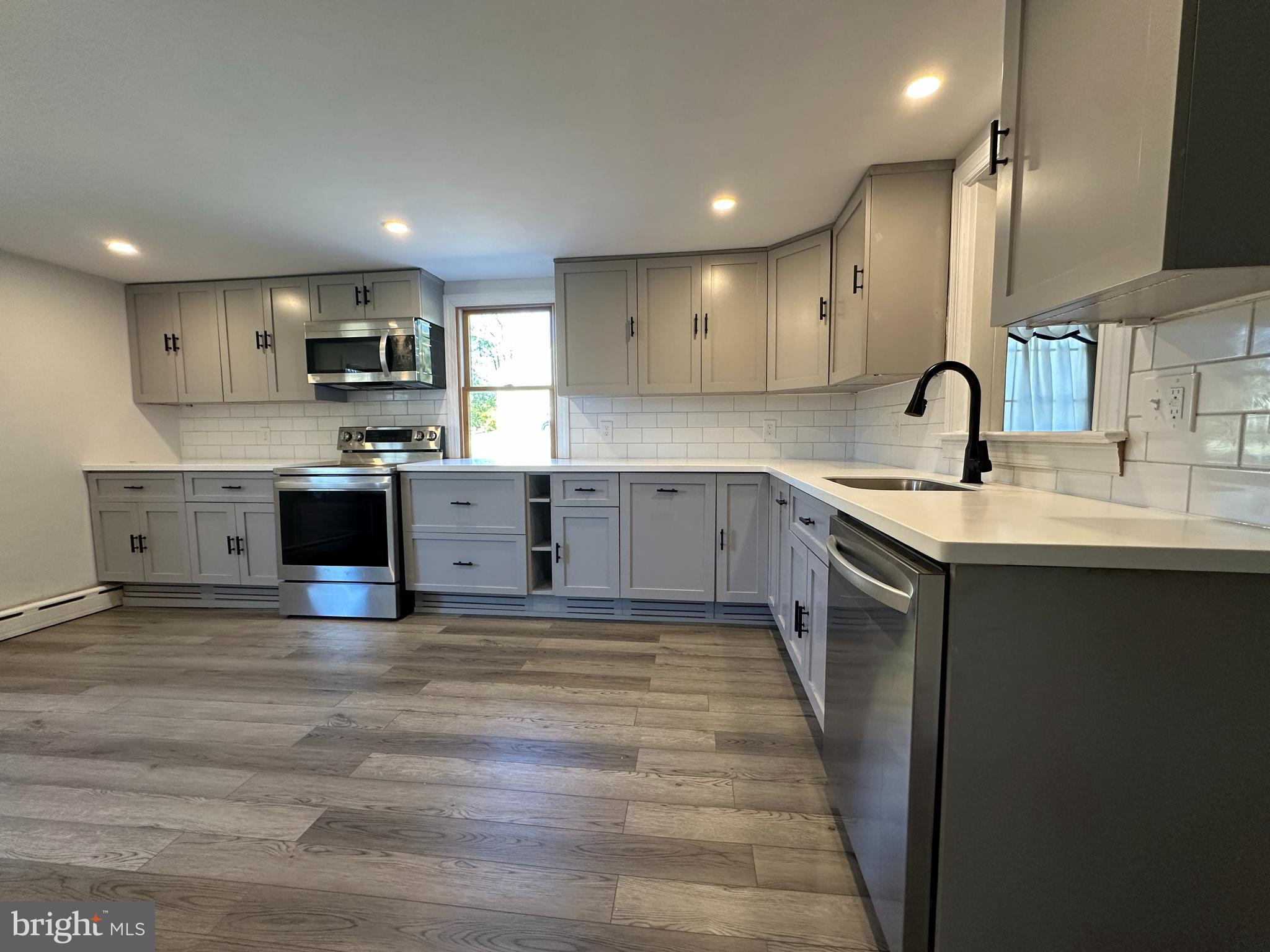 21 Big Road Schwenksville, PA 19473 - Photo 8 of 61 a kitchen with stainless steel appliances granite countertop a sink stove and cabinets