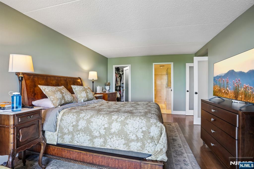 1077 River Road, Unit 303 Edgewater, NJ 07020 - Photo 14 of 27 a bed room with a bed and a television