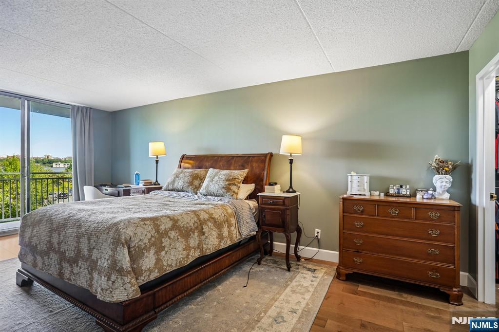 1077 River Road, Unit 303 Edgewater, NJ 07020 - Photo 16 of 27 a bedroom with a bed and window