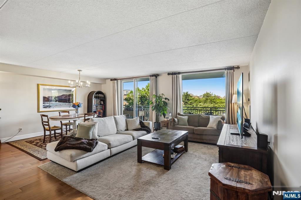 1077 River Road, Unit 303 Edgewater, NJ 07020 - Photo 2 of 27 a living room with furniture and a large window