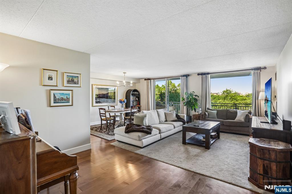 1077 River Road, Unit 303 Edgewater, NJ 07020 - Photo 3 of 27 a living room with furniture and a large window
