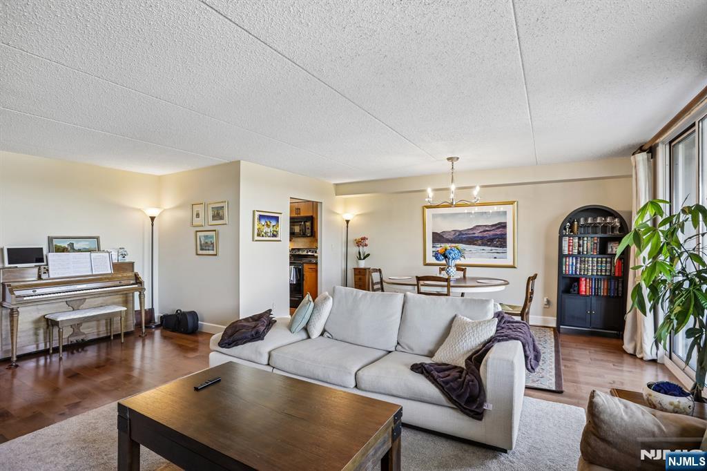 1077 River Road, Unit 303 Edgewater, NJ 07020 - Photo 5 of 27 a living room with furniture and a flat screen tv