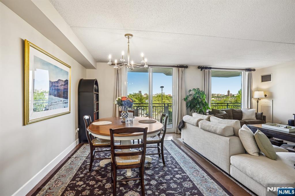 1077 River Road, Unit 303 Edgewater, NJ 07020 - Photo 7 of 27 a living room with furniture and a table