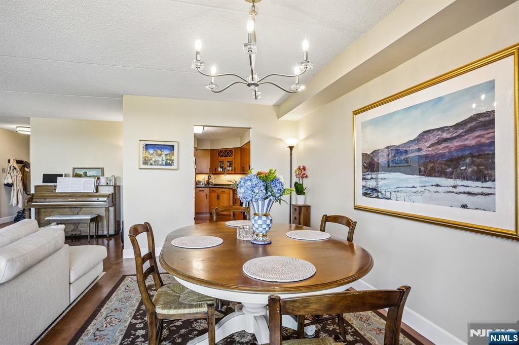 1077 River Road, Unit 303 Edgewater, NJ 07020 - Photo 8 of 27 a dining room with furniture and window