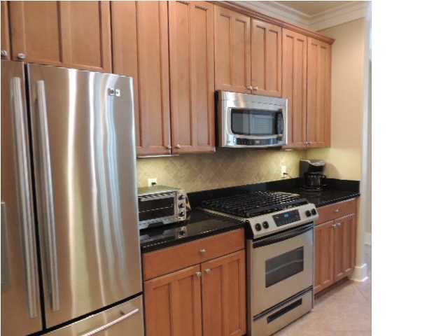 182 Preston Path Santa Rosa Beach, FL 32459 - Photo 11 of 32 a kitchen with stainless steel appliances granite countertop a refrigerator stove and microwave
