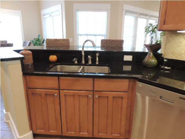 182 Preston Path Santa Rosa Beach, FL 32459 - Photo 12 of 32 a kitchen with granite countertop a sink cabinets and a window