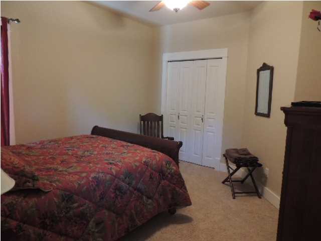 182 Preston Path Santa Rosa Beach, FL 32459 - Photo 27 of 32 a bedroom with a bed and a chair