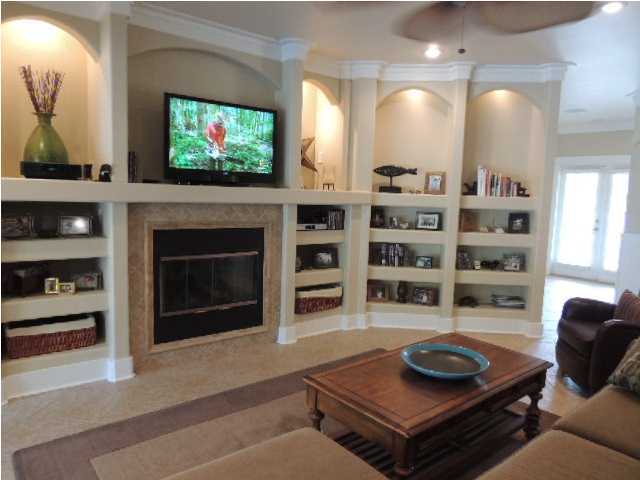 182 Preston Path Santa Rosa Beach, FL 32459 - Photo 6 of 32 a living room with furniture a flat screen tv and a fireplace
