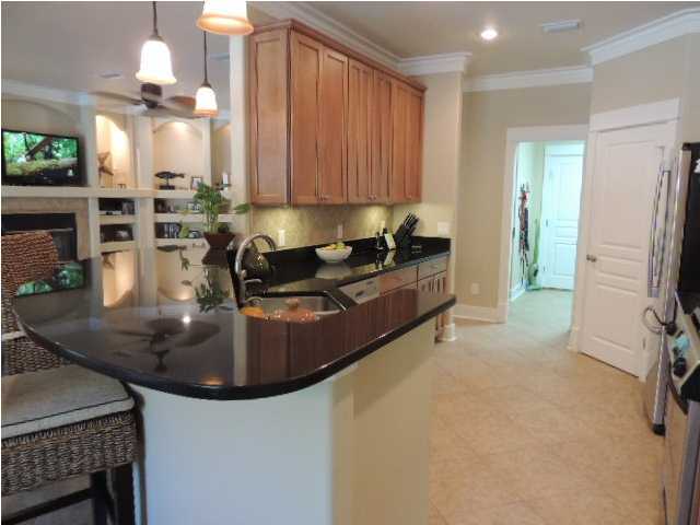 182 Preston Path Santa Rosa Beach, FL 32459 - Photo 10 of 32 a kitchen with stainless steel appliances granite countertop a sink a stove and a refrigerator