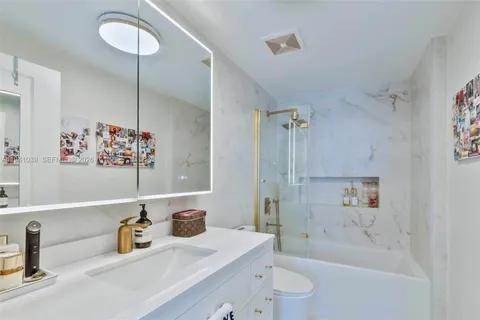 a bathroom with a sink mirror toilet and bathtub