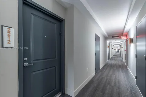 a view of hallway with wooden floor