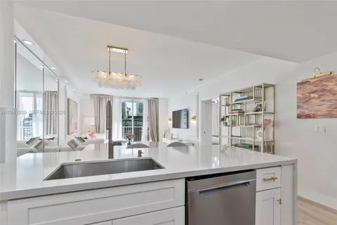 a kitchen with a sink and chandelier