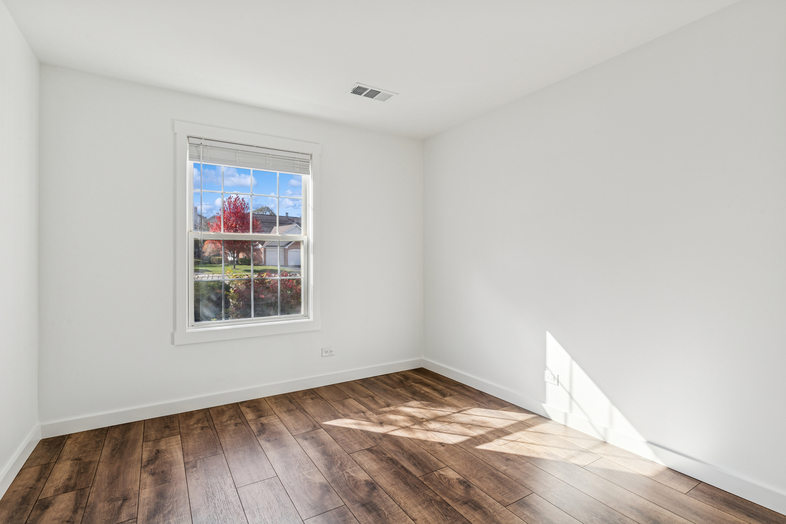 1240 Winfield Court, Unit 3 Roselle, IL 60172 - Photo 13 of 21 a view of empty room with wooden floor and fan
