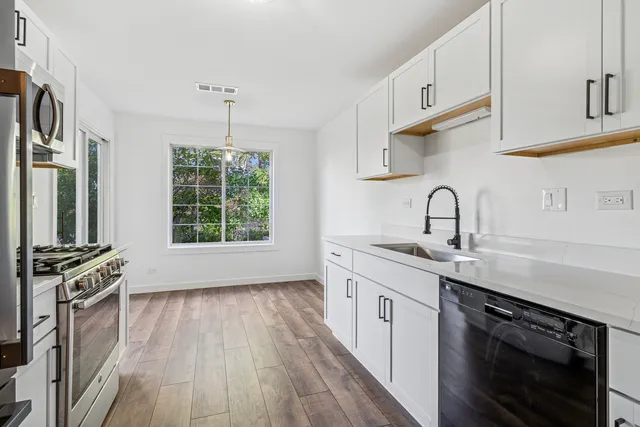a kitchen with a sink stove and cabinets