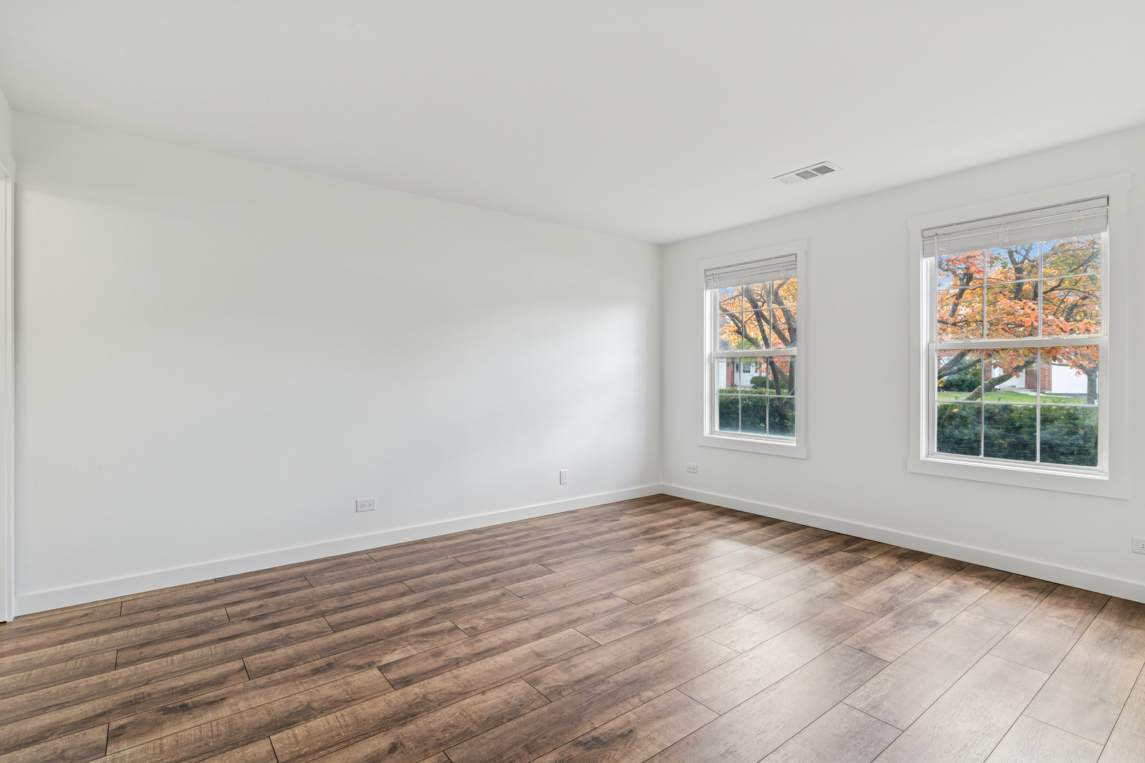 1240 Winfield Court, Unit 3 Roselle, IL 60172 - Photo 9 of 21 an empty room with wooden floor and windows