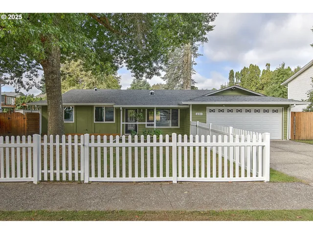 a view of a house with a wooden fence