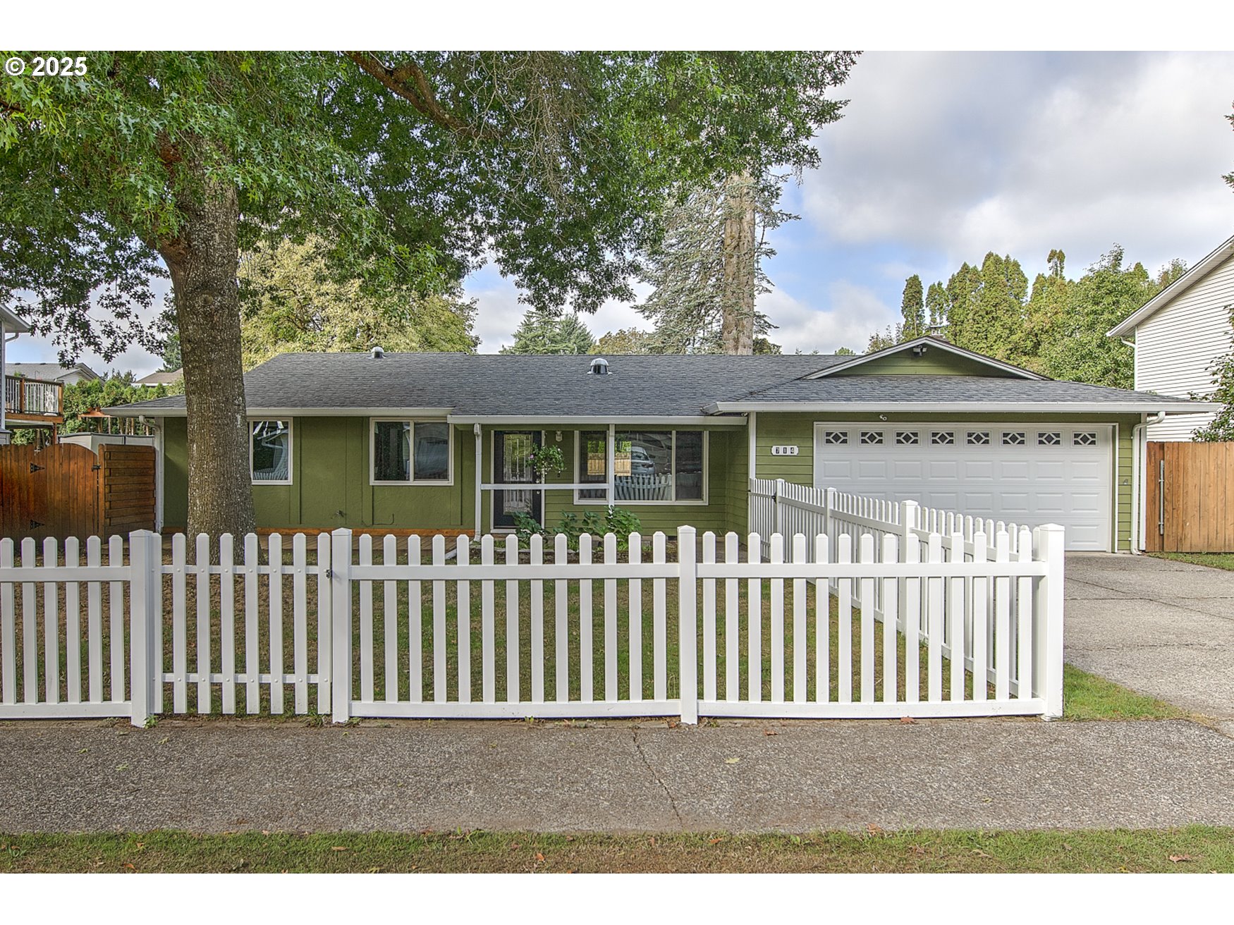 a view of a house with a wooden fence