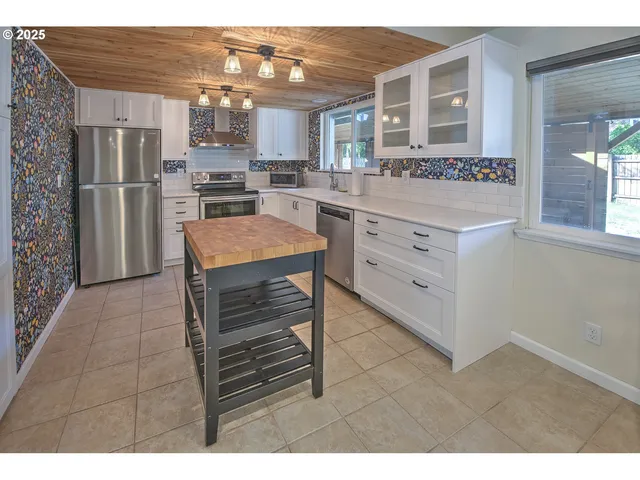a kitchen with kitchen island cabinets and refrigerator