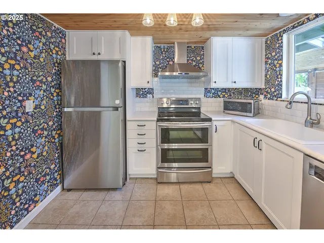 a kitchen with a stove and a refrigerator
