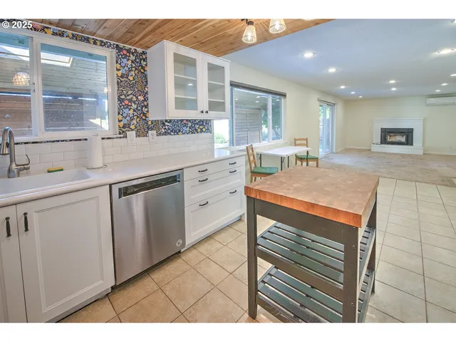a kitchen with a sink cabinets and wooden floor
