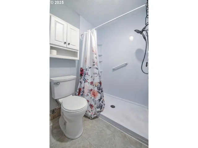 a bathroom with a toilet sink and shower