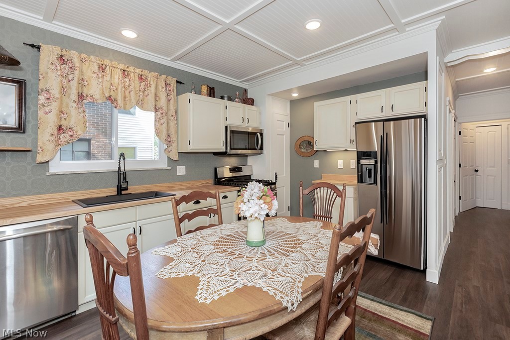 3090 Warren Road Cleveland, OH 44111 - Photo 11 of 50 Kitchen with sink, white cabinets, dark hardwood / wood-style floors, and stainless steel appliances