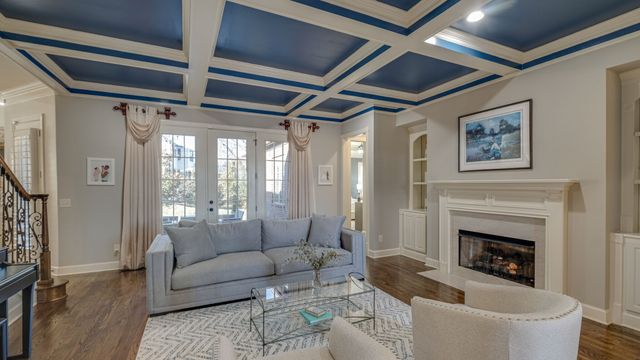 a kitchen with a dining table cabinets appliances and wooden floor