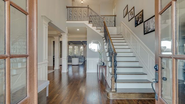 a view of entryway and hall with wooden floor