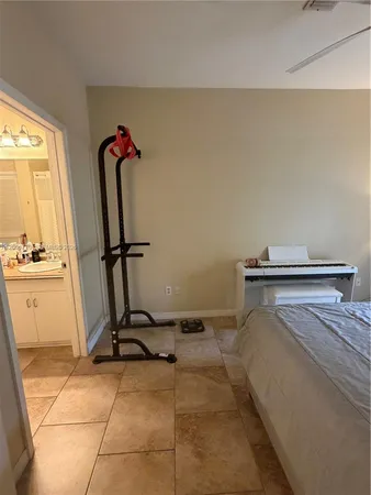 a bedroom with a bed and a large mirror on the dresser