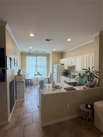 a kitchen with white cabinets and white appliances
