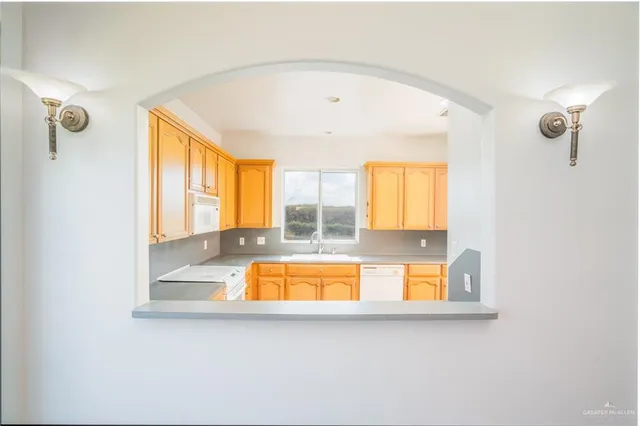 a view of a hallway with granite countertop kitchen island