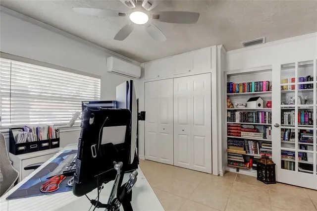 a bedroom with a workspace and a window