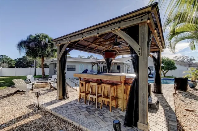 a swimming pool with outdoor seating yard and barbeque oven