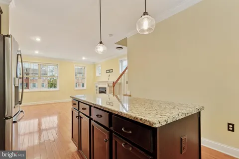 a view of kitchen and hall with wooden floor