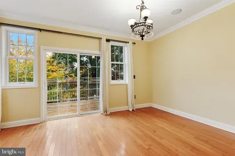 a view of a room with wooden floor and windows