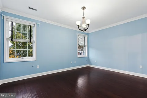 a view of a room with wooden floor and windows