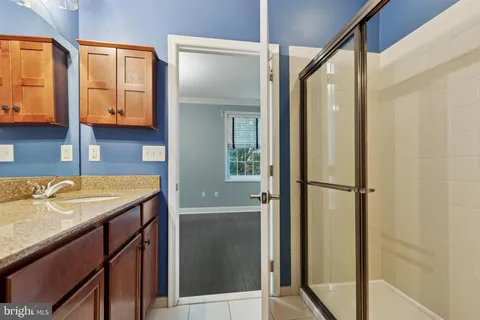 a bathroom with a granite countertop sink and mirror