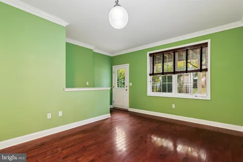 a view of room with window and hardwood