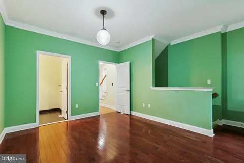 a view of room with window and wooden floor