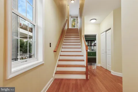 a view of entryway and hall with wooden floor