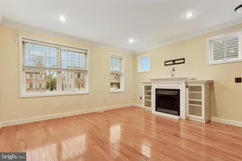 a view of an empty room with a window and fireplace
