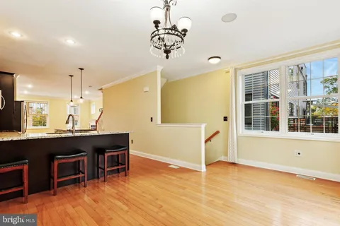 a view of a room with wooden floor and furniture