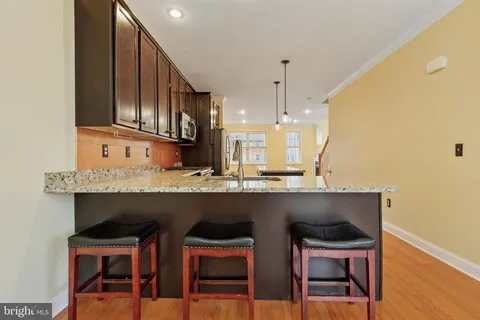 a kitchen with a table chairs refrigerator and cabinets