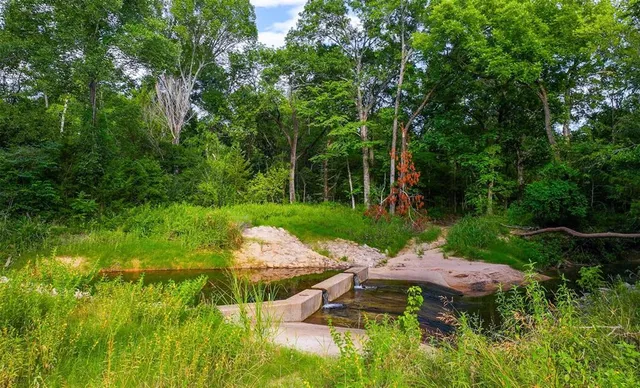 a view of a table and chairs under an umbrella