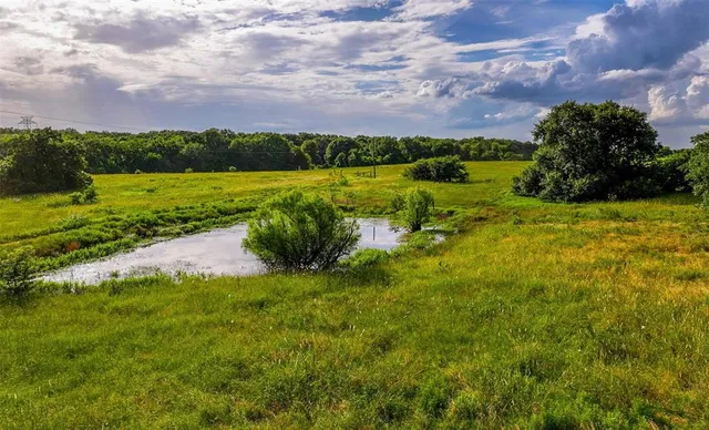 a view of a lake with a house in the background