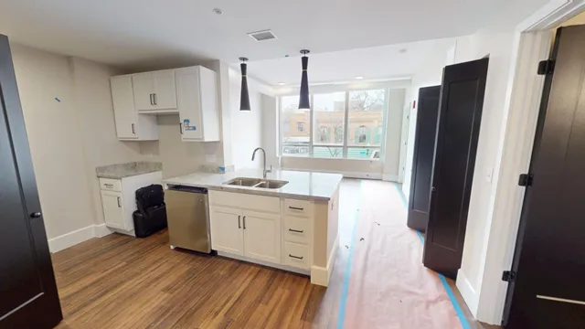 a kitchen with a refrigerator sink and a window