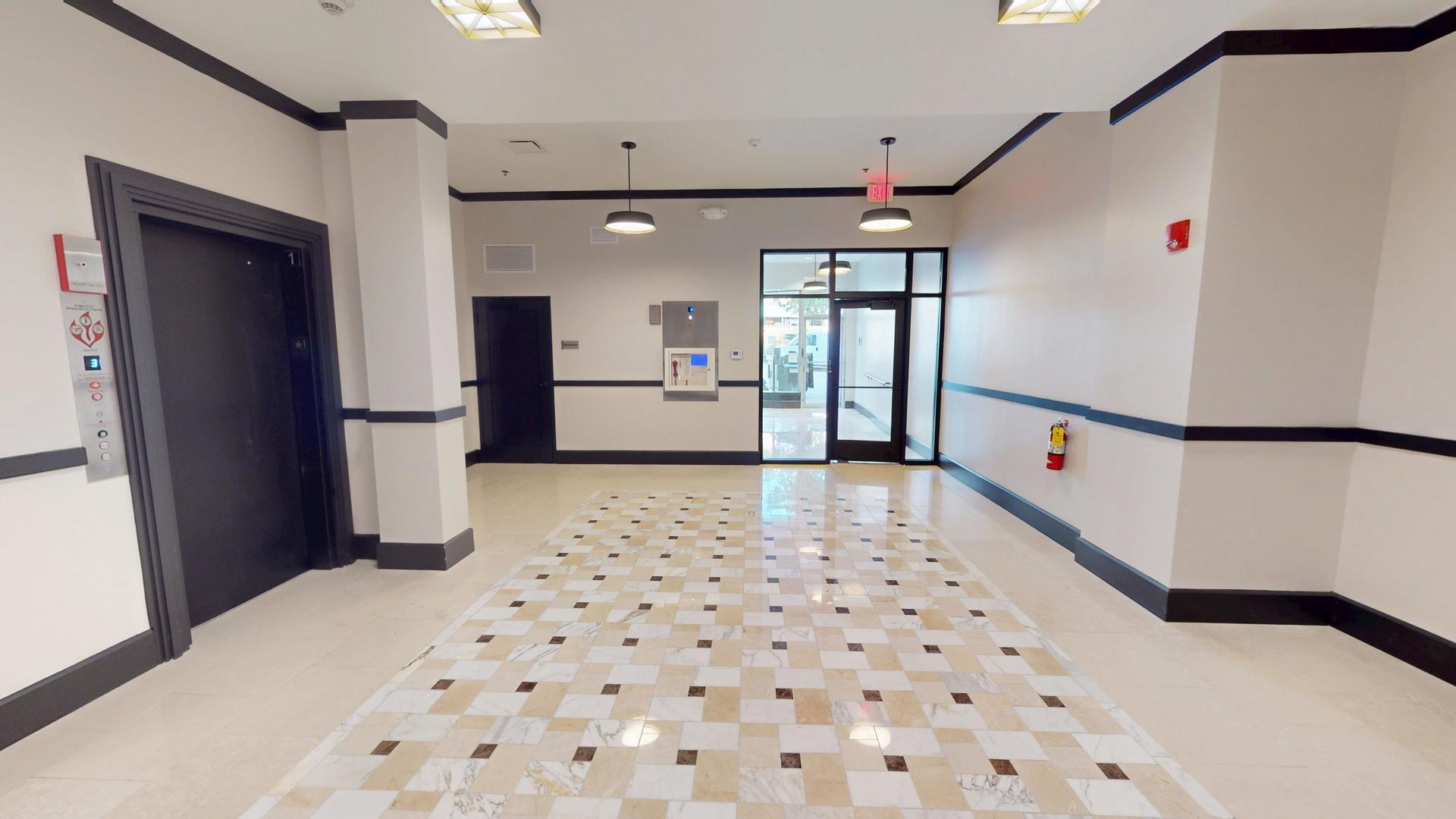 40 Dupage Court, Unit 509 Elgin, IL 60120 - Photo 7 of 9 a hallway with windows and wooden floor