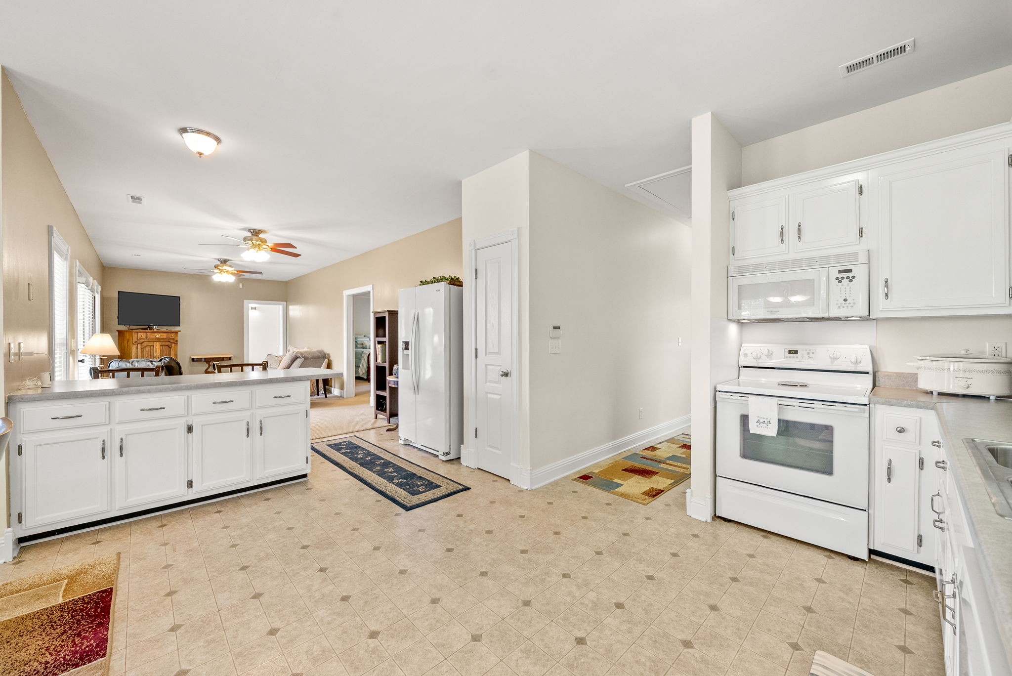 196 Wildlife Road Dover, TN 37058 - Photo 20 of 98 a kitchen with white cabinets and white appliances