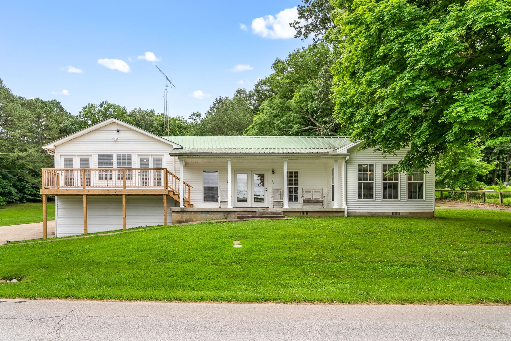 196 Wildlife Road Dover, TN 37058 - Photo 2 of 98 a front view of a house with a garden and porch